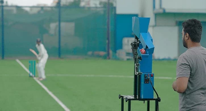 Cricket bowling machine set up on a practice net