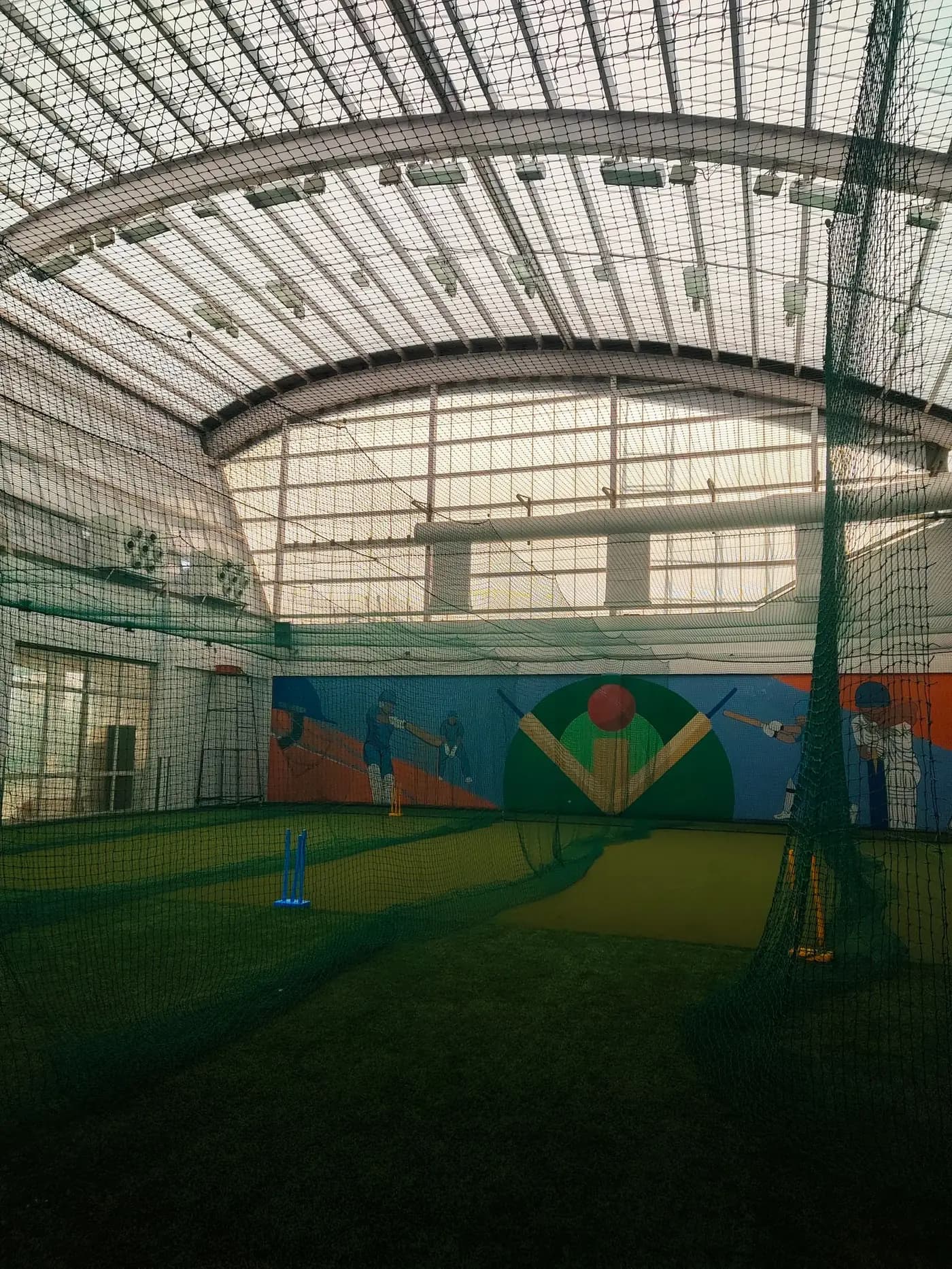 Indoor practice hall with roofed nets, used for training year-round